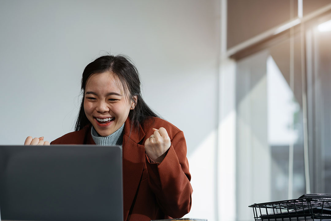 CC-Woman-Celebrating-at-Laptop woman celebrating success